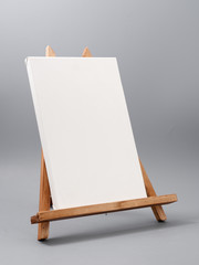 easel made of wood table on a gray background