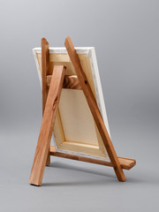 easel made of wood table on a gray background