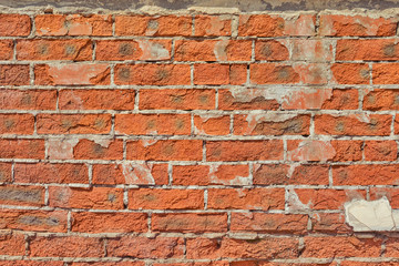 Background of collapsing red brick wall, texture of old cracked brickwork