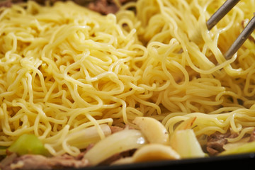 Cooking stir fried noodle with meat