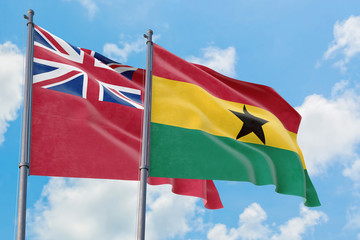 Ghana and Bermuda flags waving in the wind against white cloudy blue sky together. Diplomacy concept, international relations.
