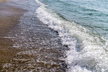 Soft wave of the sea on the sandy beach