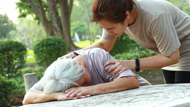 Sick asian senior woman fainted unconscious at the table, fall face down,elderly female patient stop breathing due to heart failure, cardiac arrest,severe arrhythmia, sudden unexpected death syndrome