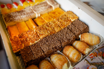 Shallow depth of field (selective focus) image with details of various types of sweet cakes.