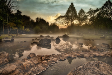 Hot Springs Onsen Natural Bath at National Park Chae Son, Lampang Thailand.In the morning sunrise.Natural hot spring bath surrounded by mountains in northern Thailand.soft focus..