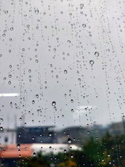 Water drops on glass, rain on a window background. drops of water-repellent surface in black &...