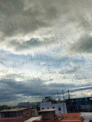 Water drops on glass, rain on a window background. drops of water-repellent surface in black &...