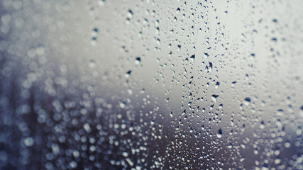 Close up of water droplets on glass. Window with rain drops. 