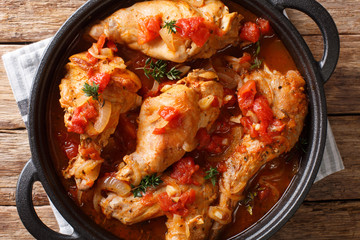 Cunillo stew of rabbit in tomato sauce with white wine and herbs close-up in a pan. Horizontal top...