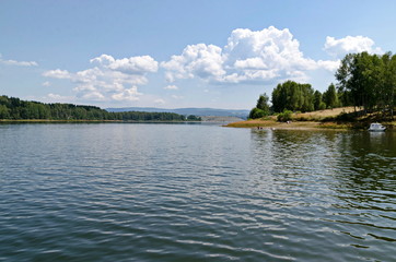General view of the artificial Vlasina mountain lake surrounded by a pine tree forest in summer, Southeastern Serbia, Europe 