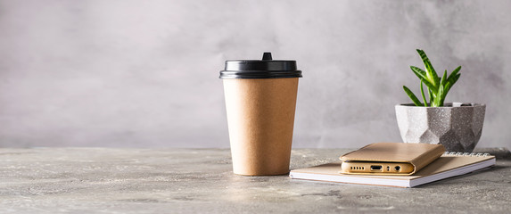 Paper cup with coffee drink or tea notepad phone on the desktop. Business lunch concept break zero...