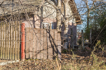 Abandoned wooden gate old derelict house on the outskirts of the city 