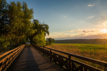 Obraz na płótnie Canvas Footbridge on the Olecko Wielkie lake in Olecko, Masuria, Poland