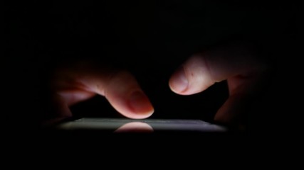 Man Hands Typing text on smartphone at night. - Powered by Adobe