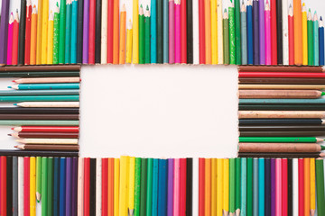 Colorful Crayons - Pencils on White Background with Empty Space In the Middle for Creative Graphic Designs