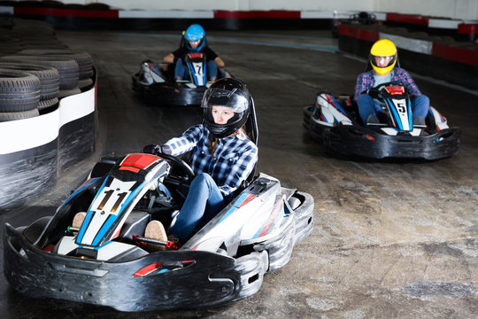 Young people driving sport cars for karting
