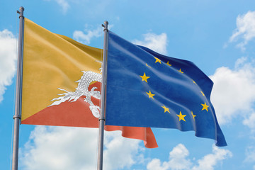 European Union and Bhutan flags waving in the wind against white cloudy blue sky together. Diplomacy concept, international relations.