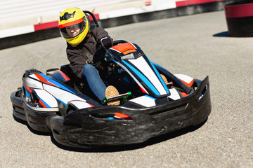 Woman driving sport car for karting  in a circuit lap outdoor in sport club