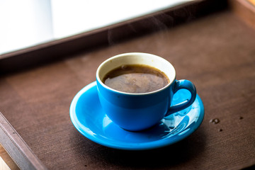 Blurred background view of a mug or coffee cup, a cup of water or a drink on the table, for customer service in a room or restaurant