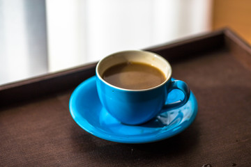 Blurred background view of a mug or coffee cup, a cup of water or a drink on the table, for customer service in a room or restaurant