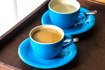 Blurred background view of a mug or coffee cup, a cup of water or a drink on the table, for customer service in a room or restaurant