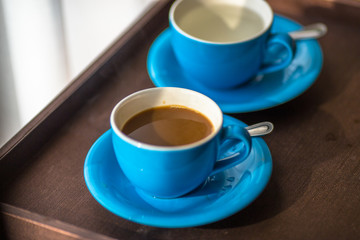 Blurred background view of a mug or coffee cup, a cup of water or a drink on the table, for customer service in a room or restaurant