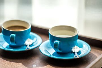 Blurred background view of a mug or coffee cup, a cup of water or a drink on the table, for customer service in a room or restaurant