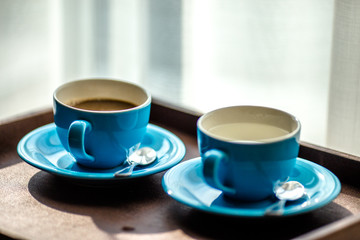 Blurred background view of a mug or coffee cup, a cup of water or a drink on the table, for customer service in a room or restaurant