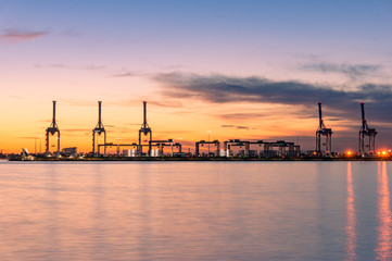Sunset landscape with silhouettes of lifting cranes and frames at Port Melbourne