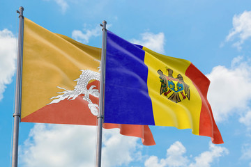 Moldova and Bhutan flags waving in the wind against white cloudy blue sky together. Diplomacy concept, international relations.