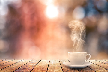 hot coffee on the table on a winter background - obrazy, fototapety, plakaty