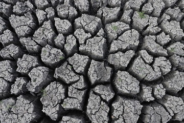 Black background, cracked ground, drought soil, dry soil and mud, dry soil