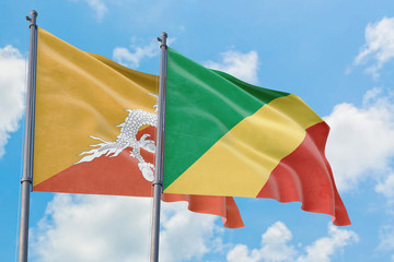 Republic Of The Congo and Bhutan flags waving in the wind against white cloudy blue sky together. Diplomacy concept, international relations.