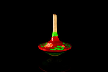 Gyroscope. Spinning top on a black background with reflection	