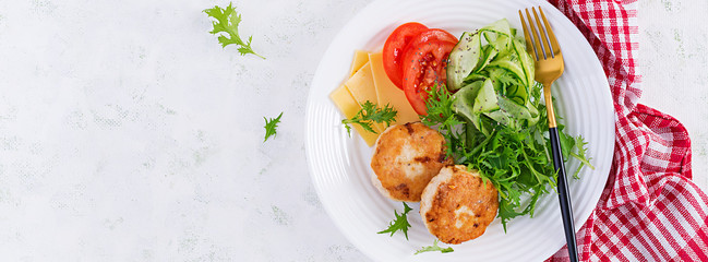 Ketogenic lunch. Chicken burger with tomato, cucumber, cheese and arugula salad without bun. Chicken patties. Healthy food. Keto/paleo diet. Top view, banner
