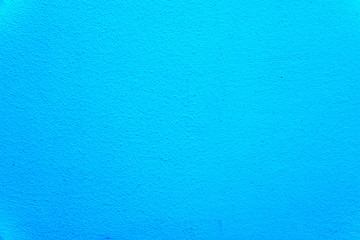 Fototapeta na wymiar Texture of an uneven wall with rough edges, blue background close-up