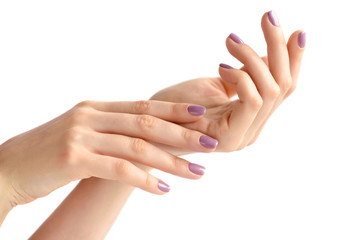 Closeup of hands of a young woman with pink manicure on nails against white background