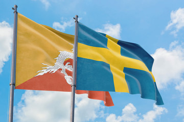 Sweden and Bhutan flags waving in the wind against white cloudy blue sky together. Diplomacy concept, international relations.
