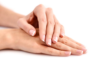 Beautiful woman hands with french manicure on a white background - obrazy, fototapety, plakaty