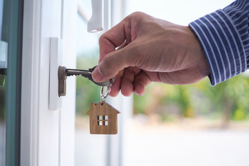Landlord unlocks the house key for new home.