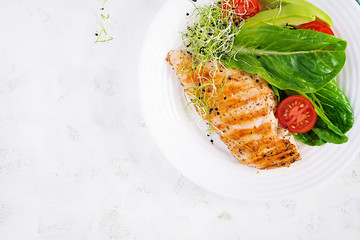 Chicken grilled fillet with salad fresh tomatoes and avocado. Healthy food, ketogenic diet, diet lunch concept. Keto/Paleo diet menu. Top view, flat lay