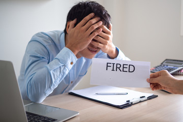Business men are stressed and frustrated after receiving a dismissal letter from management.