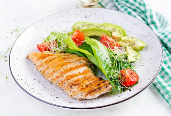 Chicken grilled fillet with salad fresh tomatoes and avocado. Healthy food, ketogenic diet, diet lunch concept. Keto/Paleo diet menu.