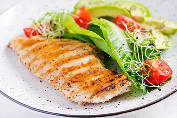 Chicken grilled fillet with salad fresh tomatoes and avocado. Healthy food, ketogenic diet, diet lunch concept. Keto/Paleo diet menu.