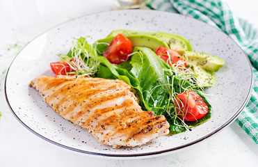 Chicken grilled fillet with salad fresh tomatoes and avocado. Healthy food, ketogenic diet, diet lunch concept. Keto/Paleo diet menu.