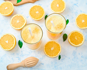 orange juice in a glass, top view, slices of oranges, straw, healthy lifestyle concept