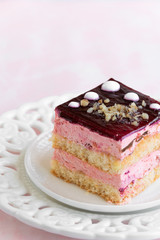 Yummy slice of strawberry cake on pink background, creamy dessert, holiday themes