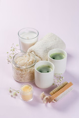 SPA concept - towel, salt, candle on pink background, copy space