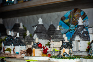 Colored souvenirs from Alberobello, South of Italy on Blurred background