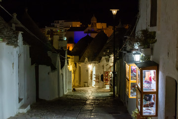 Panoramic view of the City of Alberobello with ancient traditional Italian Bluildings called Trulli at night